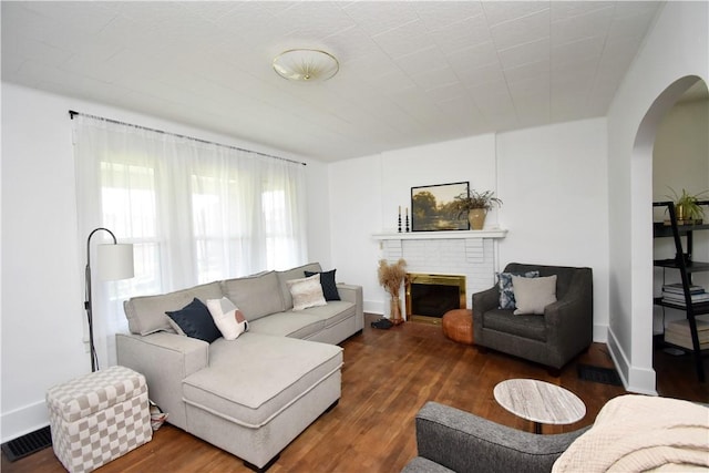 1804 Ridge Ave, Coraopolis, PA 15108 - living room featuring arched walkways, wood finished floors, and a brick fireplace