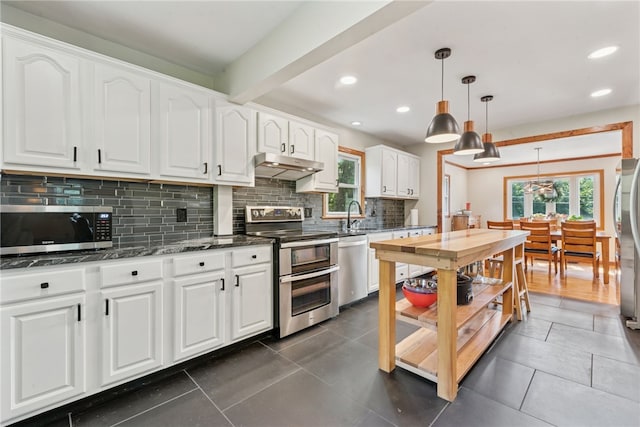 219 Tea Rose Ln, Harrison Twp, PA 15065 - kitchen featuring appliances with stainless steel finishes, under cabinet range hood, decorative backsplash, plenty of natural light, and recessed lighting