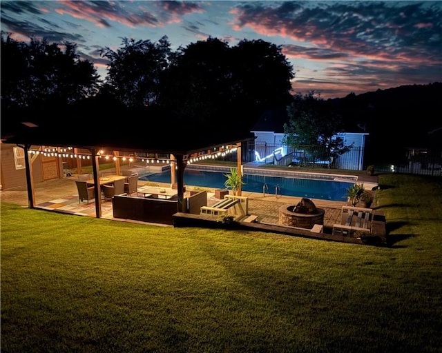219 Tea Rose Ln, Harrison Twp, PA 15065 - pool at dusk featuring a patio and an outdoor living space with a fire pit