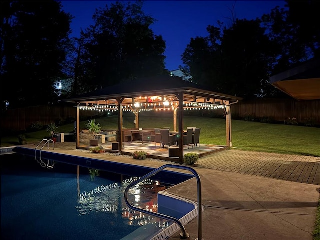 219 Tea Rose Ln, Harrison Twp, PA 15065 - pool at night featuring a gazebo, a fenced backyard, and a patio