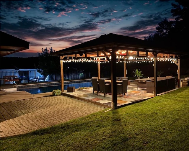 219 Tea Rose Ln, Harrison Twp, PA 15065 - patio terrace at dusk with a gazebo, outdoor lounge area, a fenced backyard, and a patio area
