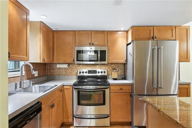 38 Foster Sq, Central North Side, PA 15212 - kitchen featuring stainless steel appliances, tasteful backsplash, recessed lighting, light stone countertops, and brown cabinets