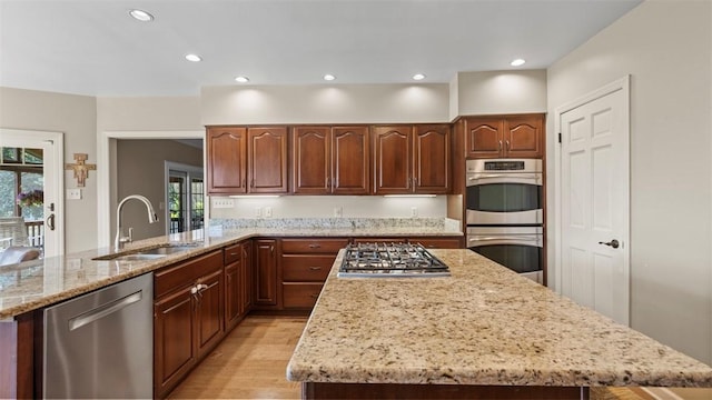 108 Trenton Cir, Peters Twp, PA 15317 - kitchen featuring appliances with stainless steel finishes, light stone countertops, light wood finished floors, recessed lighting, and a kitchen island