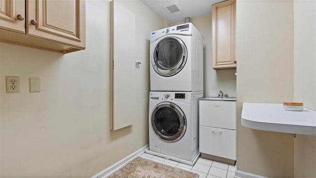 108 Trenton Cir, Peters Twp, PA 15317 - washroom featuring stacked washer / dryer, cabinet space, and light tile patterned floors