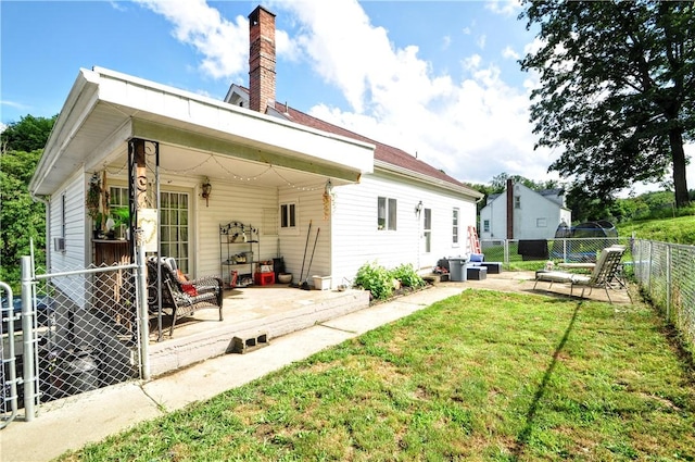 8263 Mentor Rd, Forward Twp, PA 15037 - back of property with a fenced backyard, a chimney, and a patio area