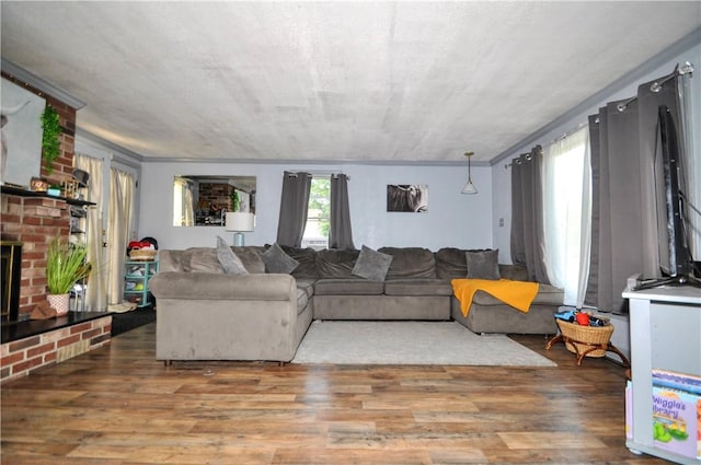 8263 Mentor Rd, Forward Twp, PA 15037 - living room featuring wood finished floors, a brick fireplace, and ornamental molding