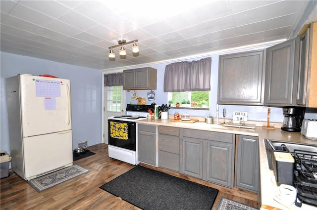 8263 Mentor Rd, Forward Twp, PA 15037 - kitchen with white appliances, wood finished floors, plenty of natural light, and gray cabinets