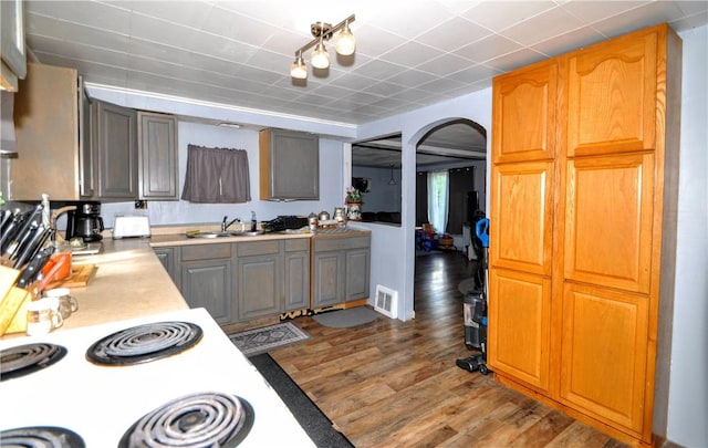 8263 Mentor Rd, Forward Twp, PA 15037 - kitchen featuring arched walkways, light countertops, and wood finished floors