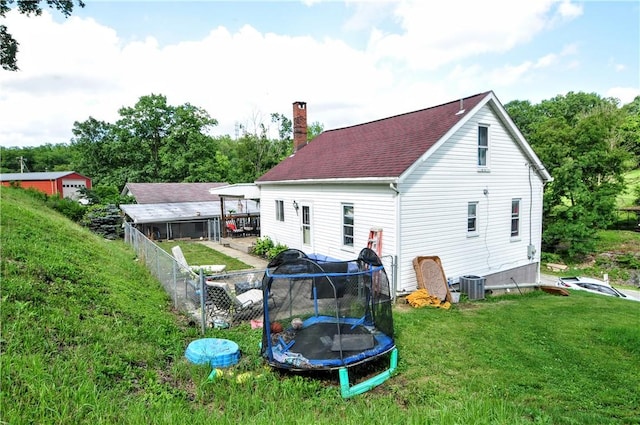 8263 Mentor Rd, Forward Twp, PA 15037 - rear view of house featuring a chimney and a trampoline