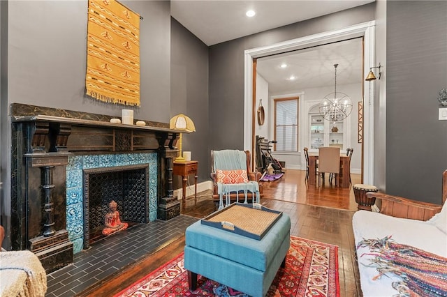 423 Lockhart St, East Allegheny, PA 15212 - living area featuring wood-type flooring, a chandelier, recessed lighting, and a tiled fireplace