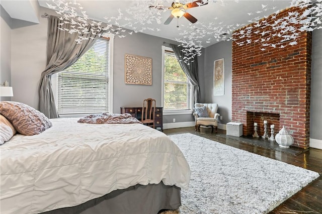 423 Lockhart St, East Allegheny, PA 15212 - bedroom with multiple windows, hardwood / wood-style flooring, a brick fireplace, and ceiling fan