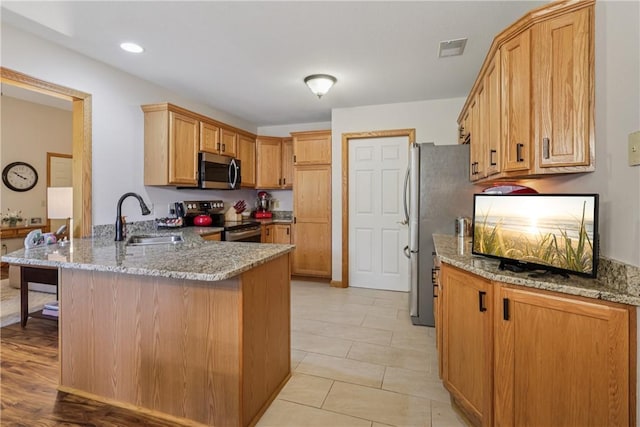 163 Nesbitt Rd, Neshannock Twp, PA 16105 - kitchen with stainless steel appliances, a peninsula, light stone counters, a kitchen bar, and recessed lighting