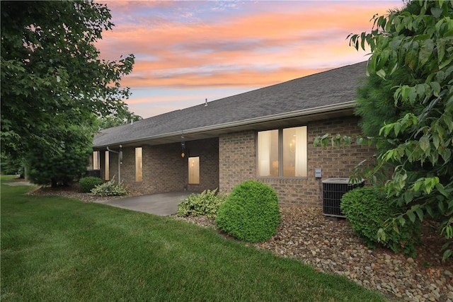 163 Nesbitt Rd, Neshannock Twp, PA 16105 - back of house featuring brick siding, a lawn, a patio, and a shingled roof