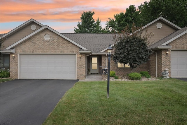 163 Nesbitt Rd, Neshannock Twp, PA 16105 - ranch-style home with driveway, a garage, brick siding, and a front lawn