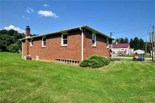 111 Wood St, Rostraver, PA 15089 - view of side of property featuring a chimney, a lawn, and brick siding