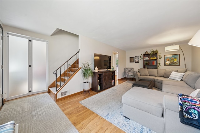 404 Atlantic Ave, Forest Hills Boro, PA 15221 - living room featuring stairway, wood finished floors, and a wall mounted air conditioner