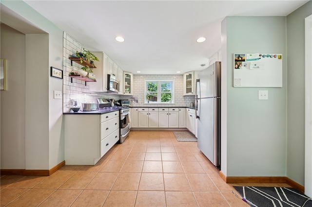 404 Atlantic Ave, Forest Hills Boro, PA 15221 - kitchen featuring stainless steel appliances, backsplash, glass insert cabinets, recessed lighting, and light tile patterned floors
