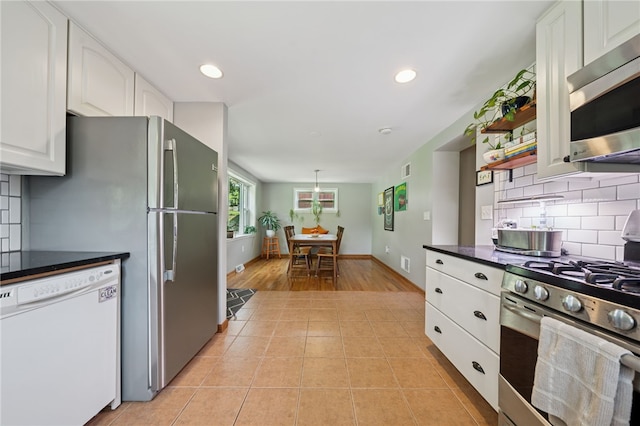 404 Atlantic Ave, Forest Hills Boro, PA 15221 - kitchen with appliances with stainless steel finishes, dark countertops, white cabinets, backsplash, and light tile patterned flooring