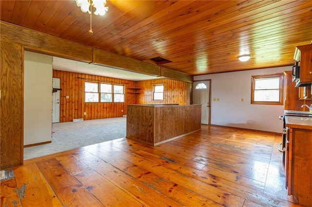 109 New Orchard Dr, Frazer, PA 15084 - kitchen featuring light wood-type flooring, open floor plan, a wood ceiling with exposed beams, brown cabinets, and wooden walls