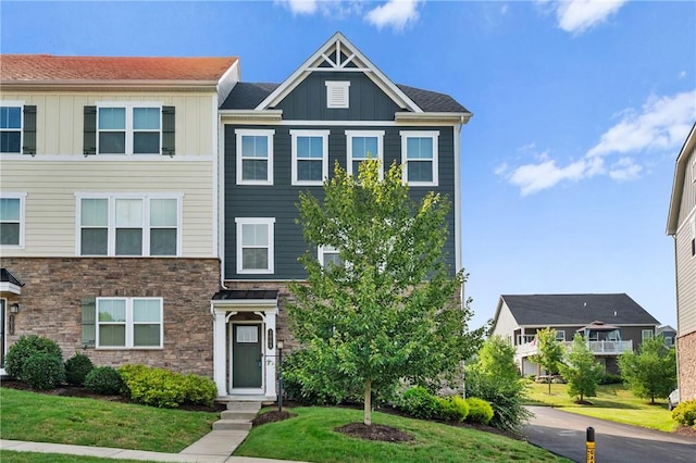 1008 Adair Ave, Middlesex Twp, PA 16059 - view of front of home with board and batten siding, stone siding, and a front yard