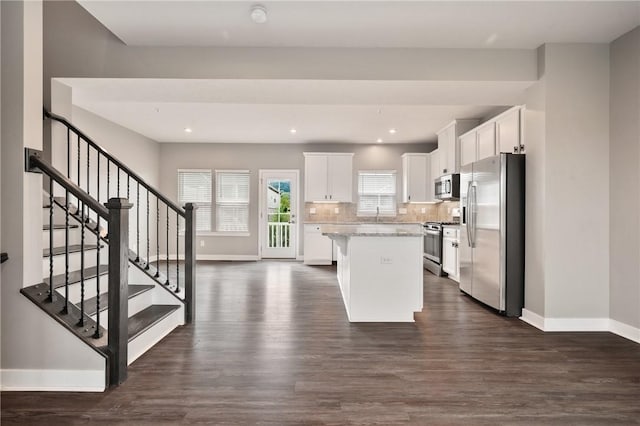 1008 Adair Ave, Middlesex Twp, PA 16059 - kitchen featuring appliances with stainless steel finishes, a center island, dark wood finished floors, white cabinetry, and decorative backsplash