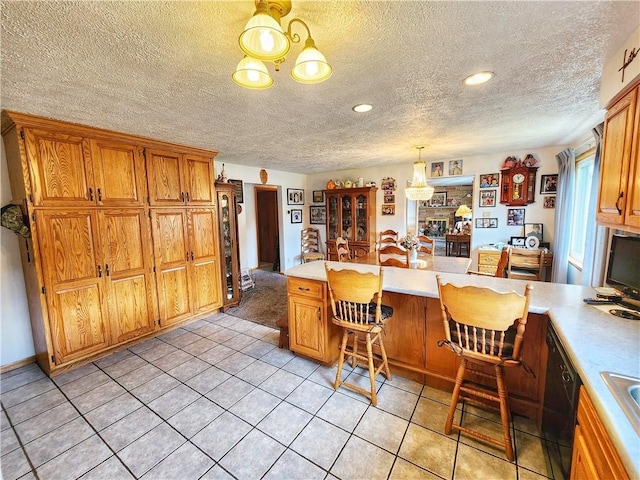 1031 Gameland Rd, Donegal, PA 16025 - kitchen featuring a chandelier, light countertops, black dishwasher, light tile patterned flooring, and a textured ceiling