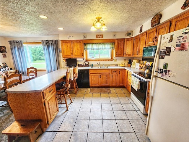 1031 Gameland Rd, Donegal, PA 16025 - kitchen featuring black appliances, a peninsula, light countertops, plenty of natural light, and a textured ceiling