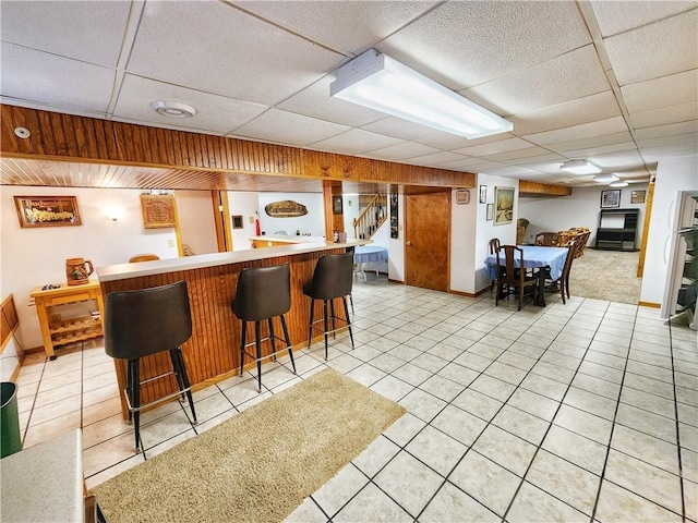 1031 Gameland Rd, Donegal, PA 16025 - kitchen with a drop ceiling, light tile patterned floors, a kitchen breakfast bar, and light countertops