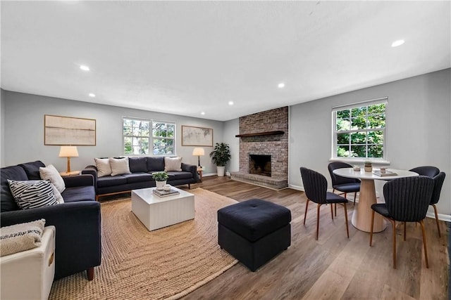 613 Newton Sq, Moon/Crescent Twp, PA 15108 - living area with wood finished floors, healthy amount of natural light, a fireplace, and recessed lighting