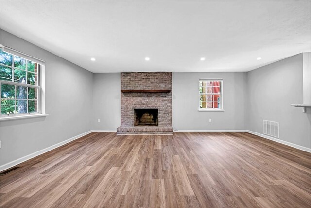 613 Newton Sq, Moon/Crescent Twp, PA 15108 - unfurnished living room featuring a brick fireplace, wood finished floors, and recessed lighting