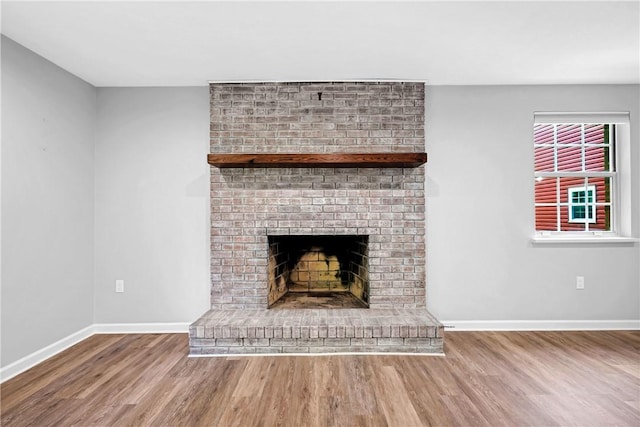 613 Newton Sq, Moon/Crescent Twp, PA 15108 - unfurnished living room featuring wood finished floors and a fireplace