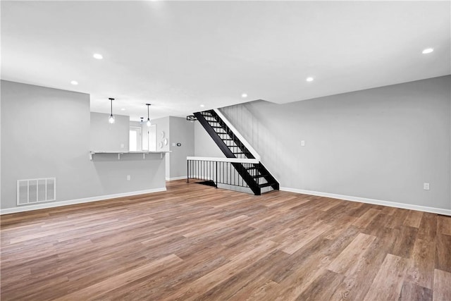 613 Newton Sq, Moon/Crescent Twp, PA 15108 - unfurnished living room featuring wood finished floors, stairs, and recessed lighting