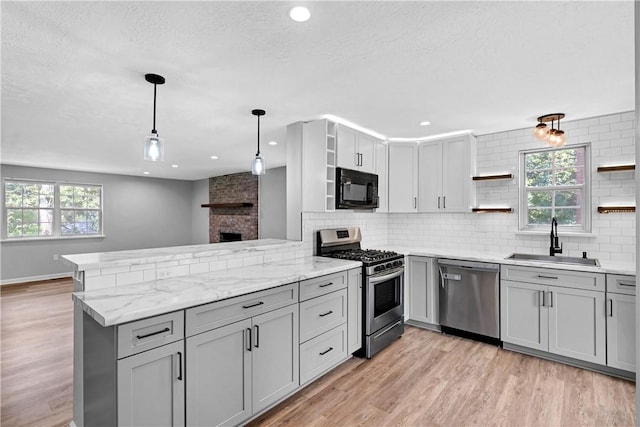 613 Newton Sq, Moon/Crescent Twp, PA 15108 - kitchen featuring open shelves, stainless steel appliances, gray cabinets, a peninsula, and a textured ceiling