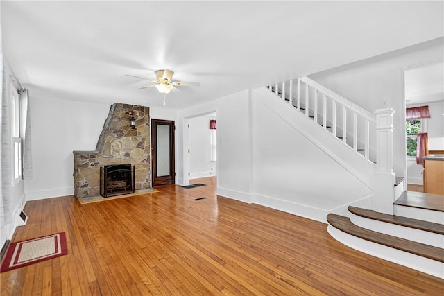222 S 8th St, West Newton, PA 15089 - unfurnished living room featuring stairs, ceiling fan, light wood-style floors, and a fireplace