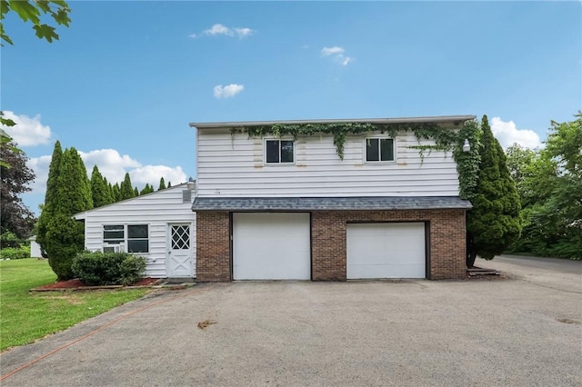 168 Debernardo Ln, Mahoning Twp, PA 16132 - view of front of house with brick siding, a garage, asphalt driveway, and a shingled roof