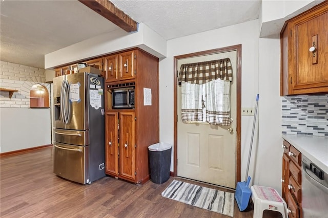 168 Debernardo Ln, Mahoning Twp, PA 16132 - kitchen with stainless steel appliances, brown cabinets, dark wood-style flooring, tasteful backsplash, and light countertops