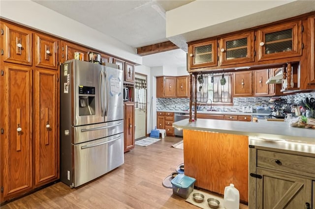 168 Debernardo Ln, Mahoning Twp, PA 16132 - kitchen featuring appliances with stainless steel finishes, brown cabinetry, light countertops, backsplash, and beam ceiling