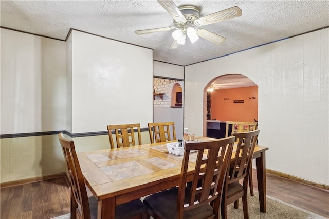 168 Debernardo Ln, Mahoning Twp, PA 16132 - dining space featuring arched walkways, a textured ceiling, a ceiling fan, and wood finished floors