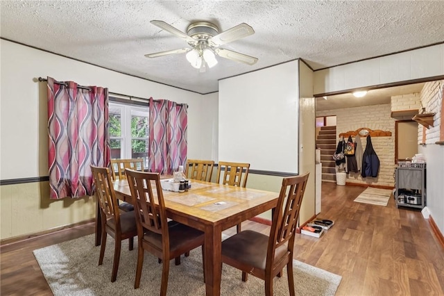 168 Debernardo Ln, Mahoning Twp, PA 16132 - dining space featuring wood finished floors, a textured ceiling, ceiling fan, and stairway