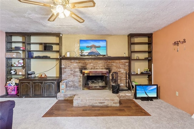 168 Debernardo Ln, Mahoning Twp, PA 16132 - carpeted living area featuring a ceiling fan, a textured ceiling, and a fireplace