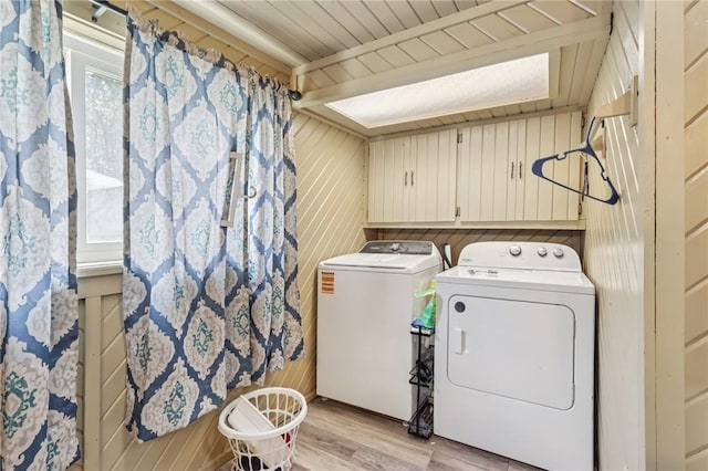 168 Debernardo Ln, Mahoning Twp, PA 16132 - laundry room featuring washing machine and clothes dryer, light wood-style flooring, and wooden walls