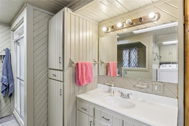 168 Debernardo Ln, Mahoning Twp, PA 16132 - bathroom featuring washer / clothes dryer, vanity, wood walls, and a stall shower