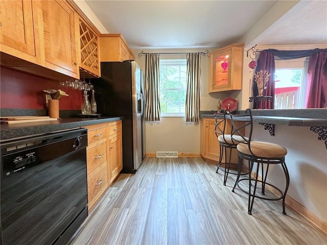 157 Aberdeen Dr, Mccandless, PA 15237 - kitchen with dishwasher, dark countertops, light wood-type flooring, a kitchen bar, and light brown cabinetry