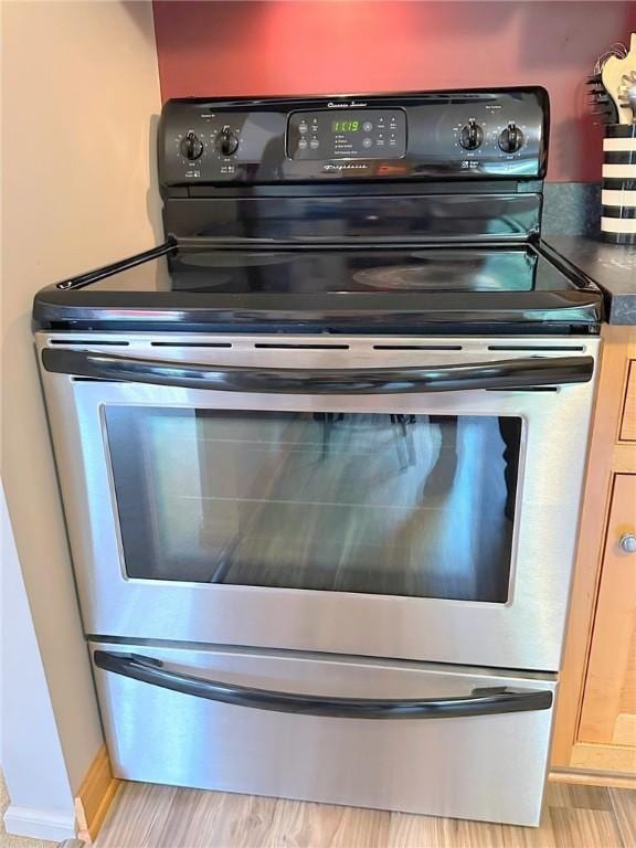 157 Aberdeen Dr, Mccandless, PA 15237 - kitchen view of electric stove, dark countertops, and light wood-style flooring