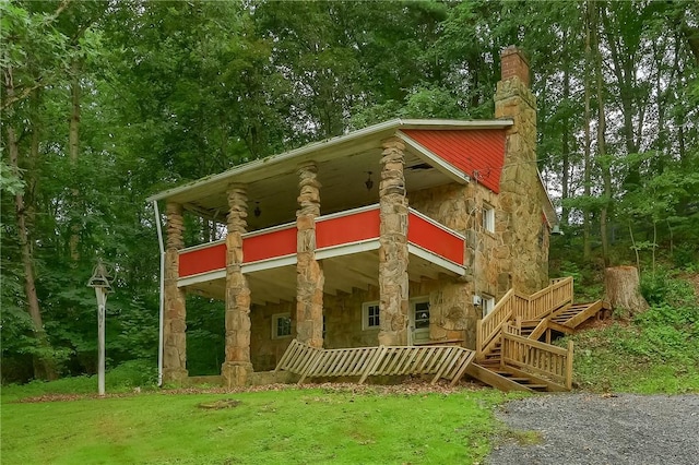 405 Cornetti Rd, Clearfield Twp, PA 16034 - view of front of house with stone siding, a balcony, a chimney, and a front yard