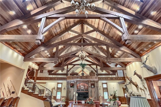 399 Cornetti Rd, Clearfield Twp, PA 16034 - living area with high vaulted ceiling, a chandelier, a wood ceiling with exposed beams, and stairs