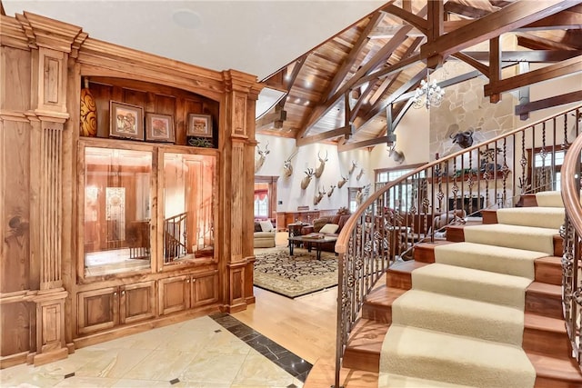 399 Cornetti Rd, Clearfield Twp, PA 16034 - staircase with high vaulted ceiling, beam ceiling, and a chandelier