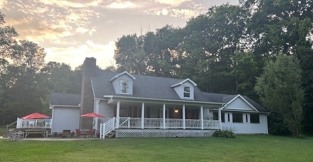 242 Coaltown Rd, Cherry Twp, PA 16020 - cape cod house with covered porch, a lawn, and a chimney
