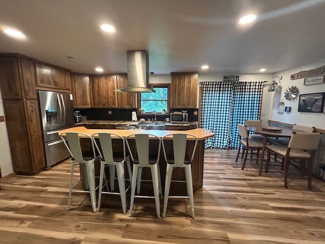 242 Coaltown Rd, Cherry Twp, PA 16020 - kitchen featuring stainless steel appliances, exhaust hood, light wood-style flooring, a kitchen island, and recessed lighting