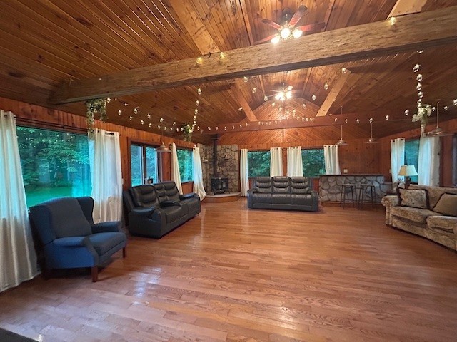 242 Coaltown Rd, Cherry Twp, PA 16020 - living area featuring wood finished floors, wooden ceiling, a ceiling fan, and wooden walls